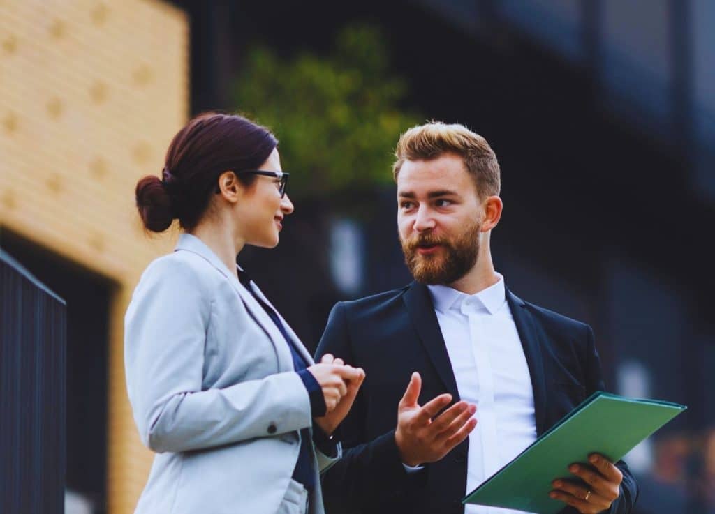 Professional conversation between agent and client, illustrating The Lenoir Team’s expert home selling strategy and guidance.