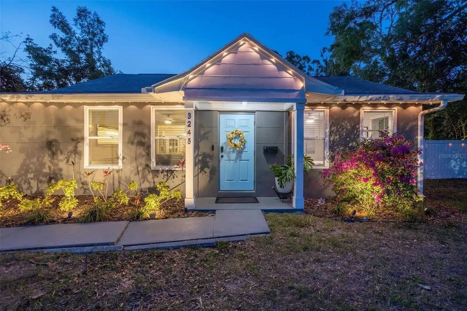 Night view of 3245 Freemont Terrace S with illuminated porch.