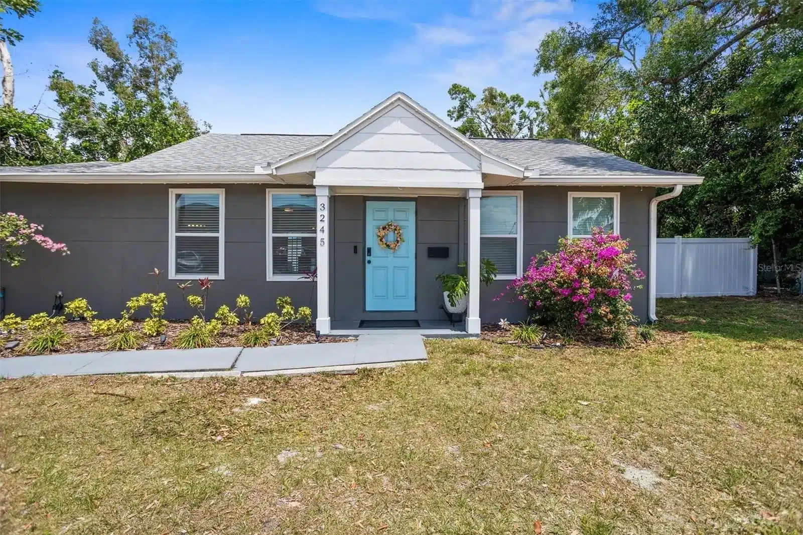 Daytime exterior of 3245 Freemont Terrace S with blue door.