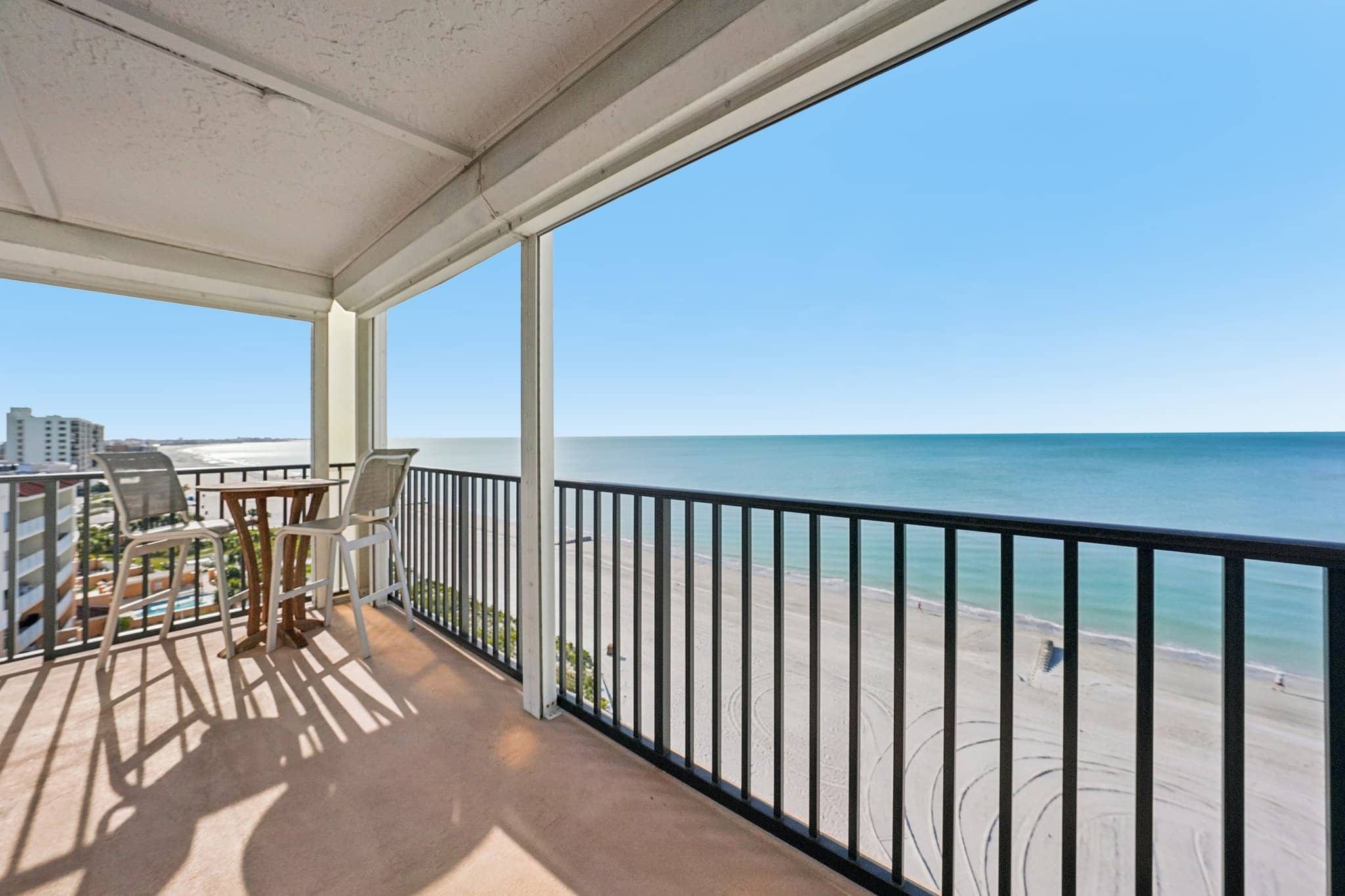 Large covered balcony with seating overlooking the Gulf of Mexico and beach at 15316 Gulf Blvd Madeira Beach FL