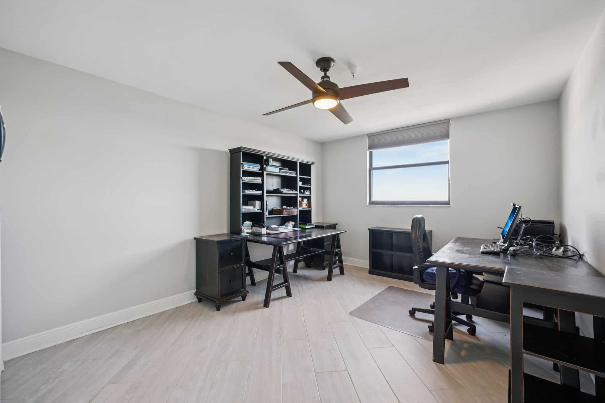 Home office or guest bedroom with desk and natural light at 15316 Gulf Blvd Madeira Beach FL