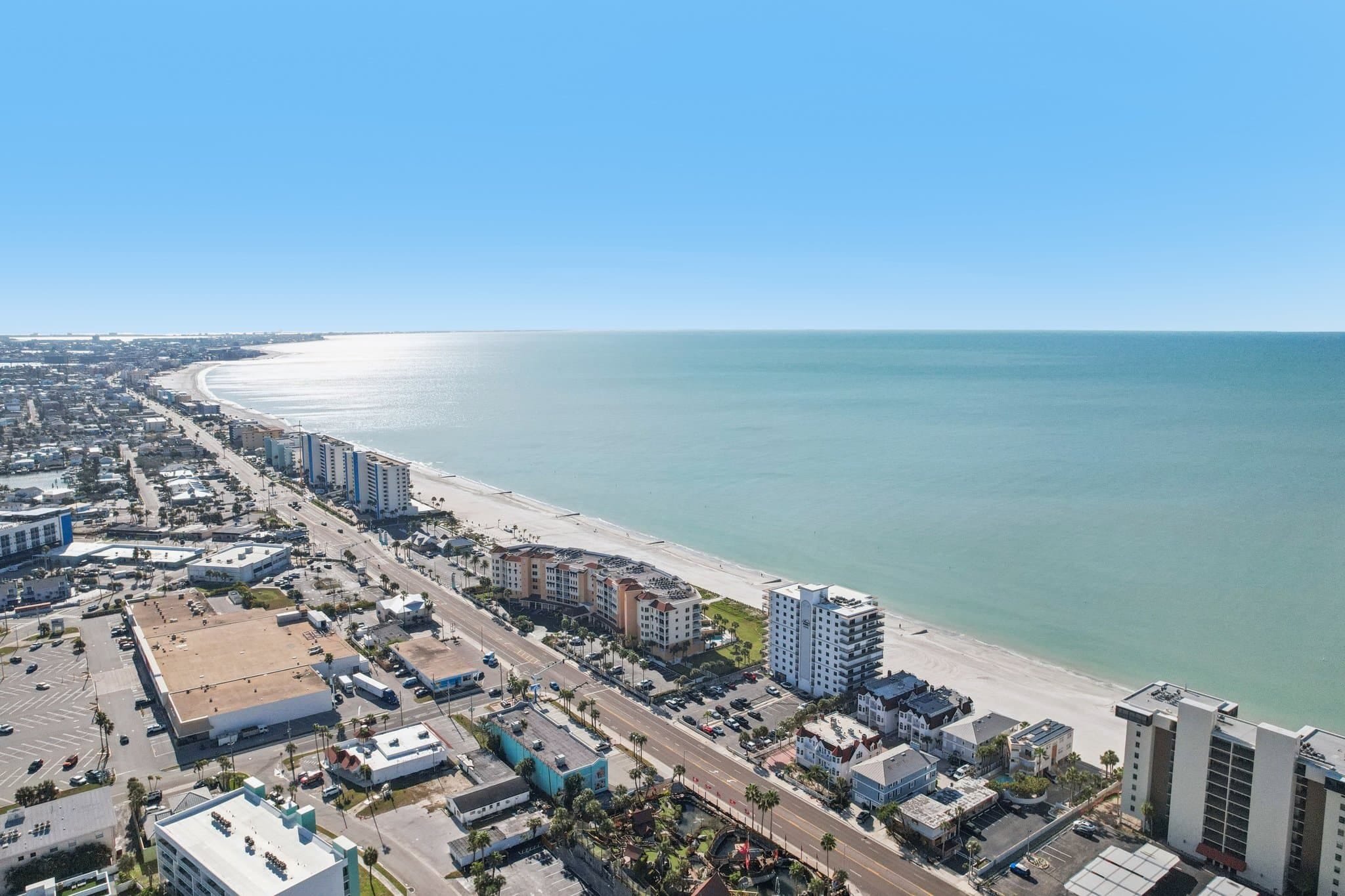Aerial view of Gulf Boulevard Madeira Beach FL with beachfront condos, roadways, and Gulf of Mexico shoreline near 15316 Gulf Blvd