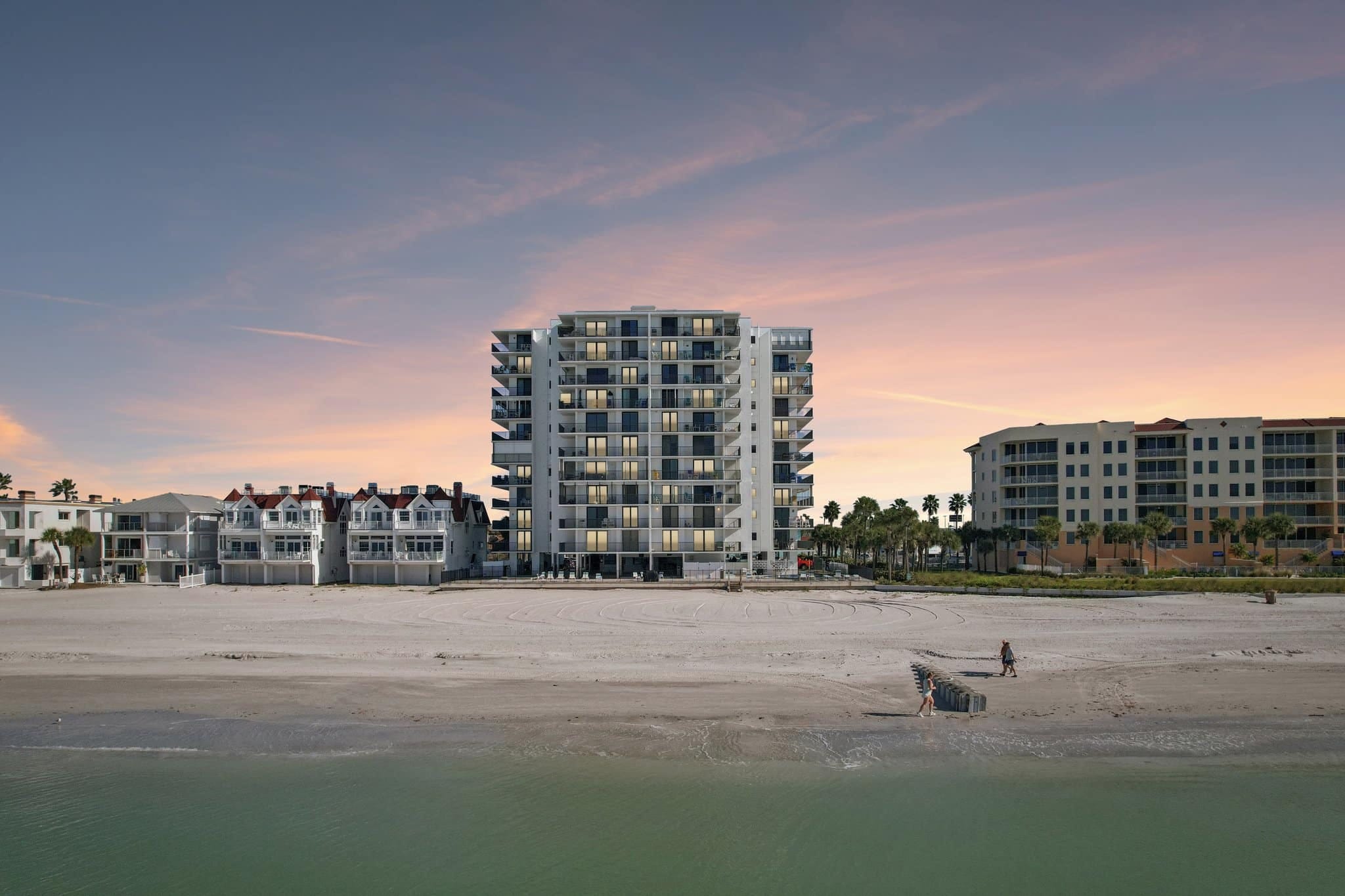 Beachfront condo at sunset with glowing sky and Gulf shoreline at 15316 Gulf Blvd Madeira Beach FL