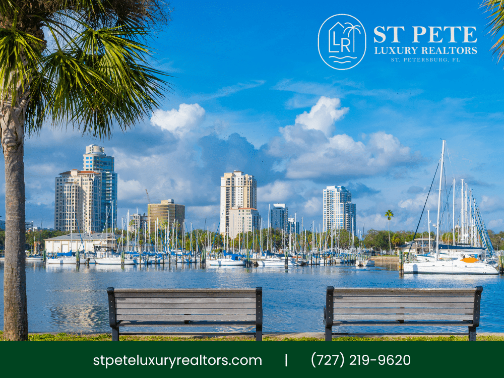 St. Petersburg waterfront with palm trees, yachts, and city skyline.