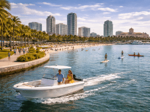 Couple boating and paddleboarders in St. Petersburg FL with beach and city skyline views